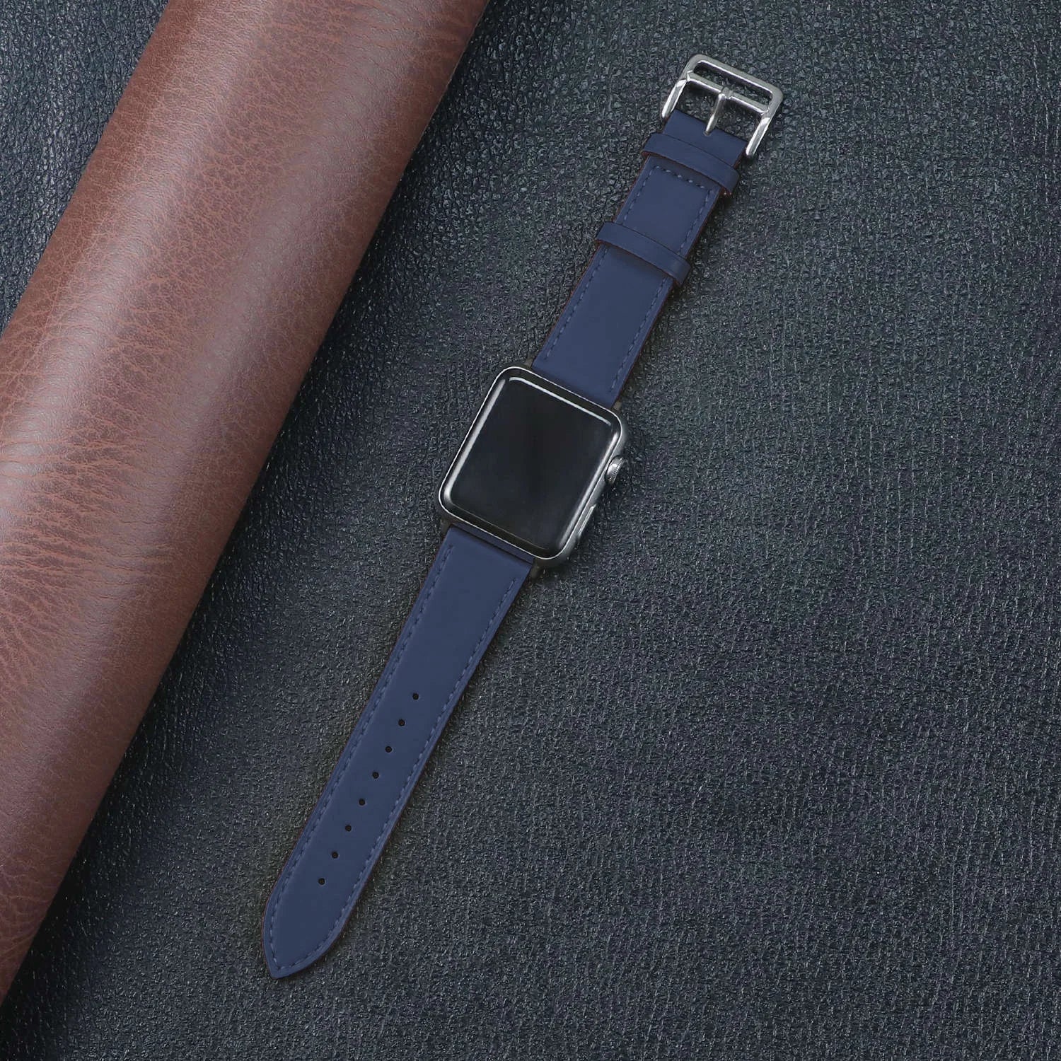 Apple Watch with a stylish blue fabric band on textured leather background, showcasing durability and comfort.