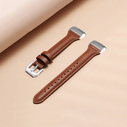 Fitbit Charge 5 slim leather band strap in brown with silver buckle, comfortable and stylish accessory for smartwatches.