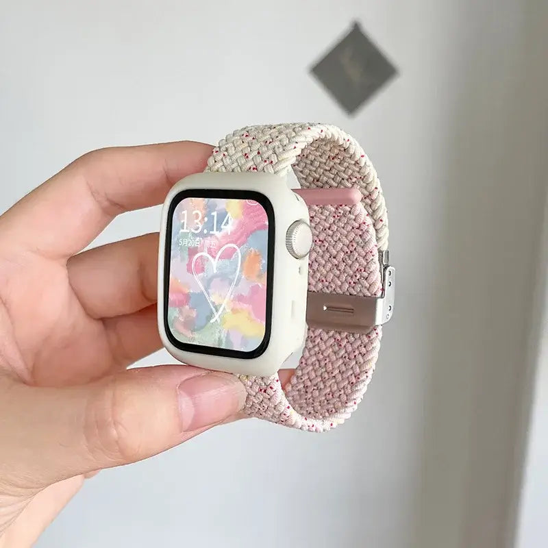 Speckled pink and beige woven Apple Watch band with white case