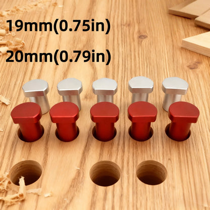 Red and silver aluminum bench dogs in workbench dog holes