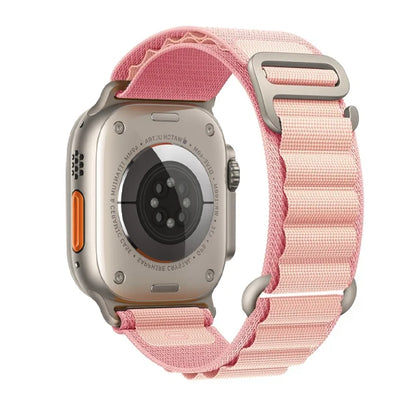 Apple Watch with pink nylon strap, featuring a rugged design for durability and comfort, perfect for outdoor adventures.
