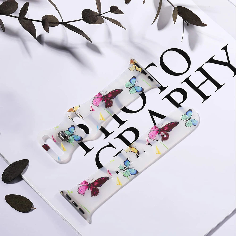 Apple Watch silicone strap featuring a colorful floral and butterfly design, perfect for style and comfort.