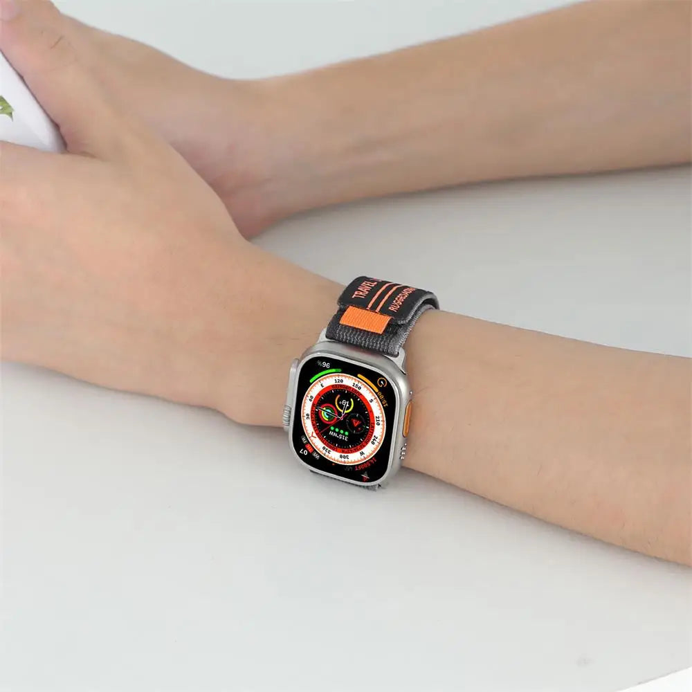 Apple Watch with Rugged Trail Loop nylon band on wrist, showcasing durability and sporty design.