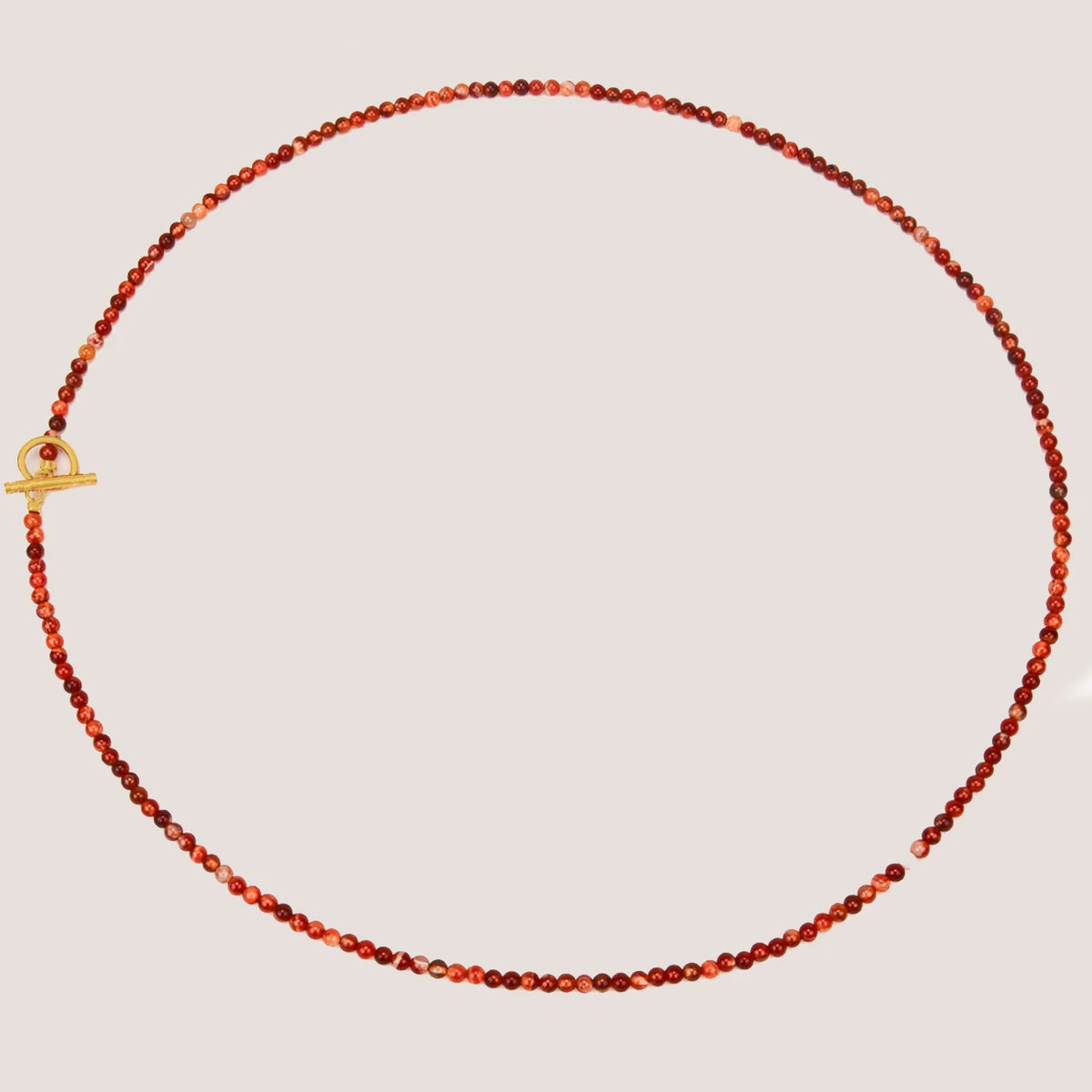 Long carnelian bead necklace laid flat
