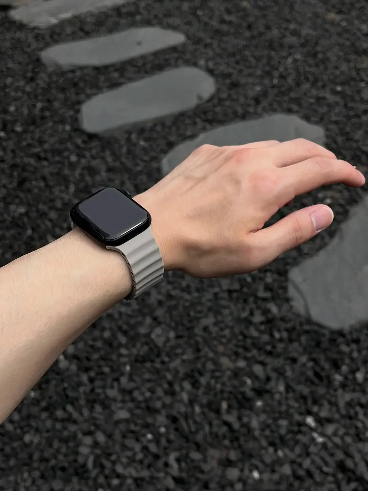 Gray ridged silicone Apple Watch band worn on wrist