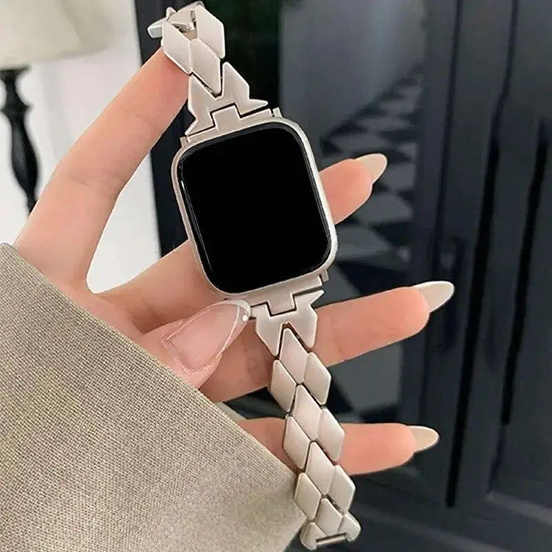 Starlight herringbone stainless steel band shown on an Apple Watch.