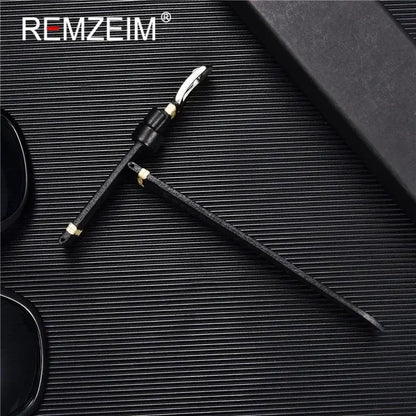 Stylish black REMZEIM sunglasses with a sleek, textured strap on a dark background, perfect for fashion-forward individuals.