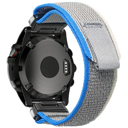 Garmin smartwatch with a rugged woven nylon replacement band, showcasing durable materials and comfort fit design.