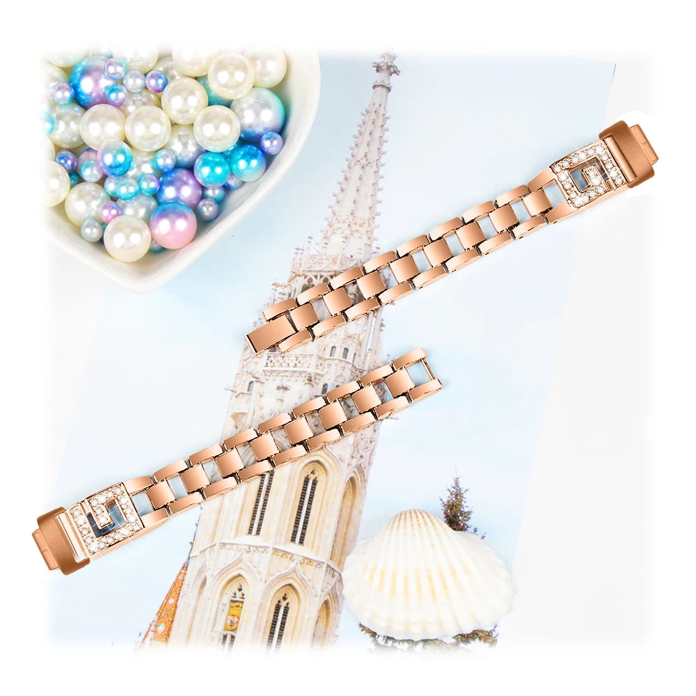 Fitbit Inspire 3 metal diamond band on a pastel background with decorative pearls, showcasing an elegant smartwatch strap.