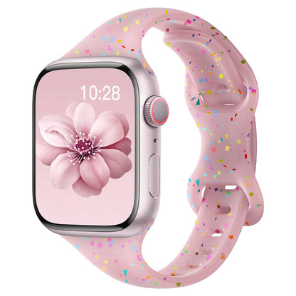 Apple Watch with pink silicone band featuring colorful confetti design and flower watch face, perfect for daily wear.