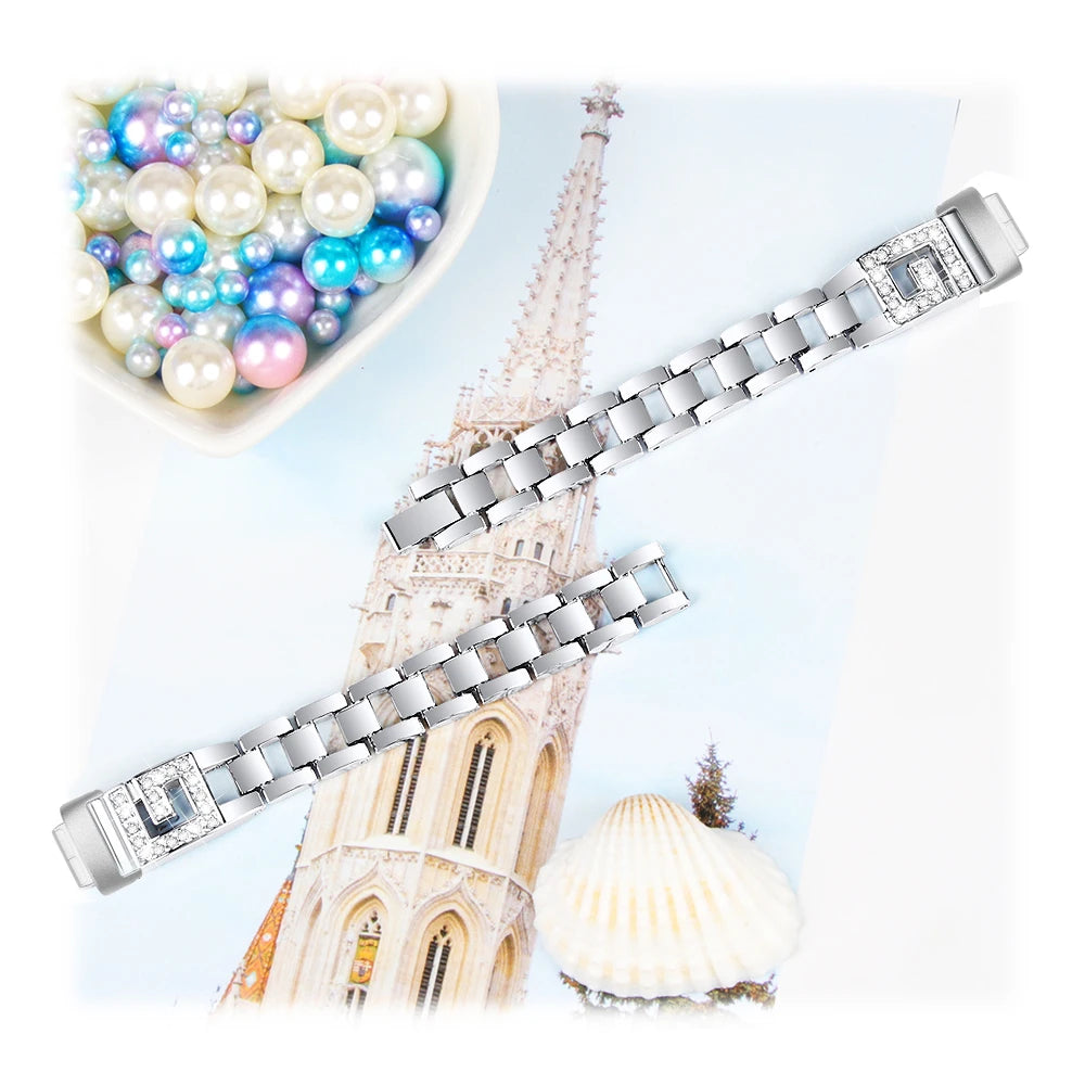 Fitbit Inspire 3 metal diamond band on a pastel background with decorative pearls, showcasing elegant design and durability.