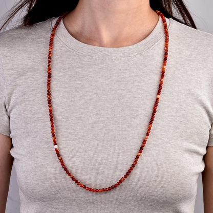 Long carnelian bead necklace worn
