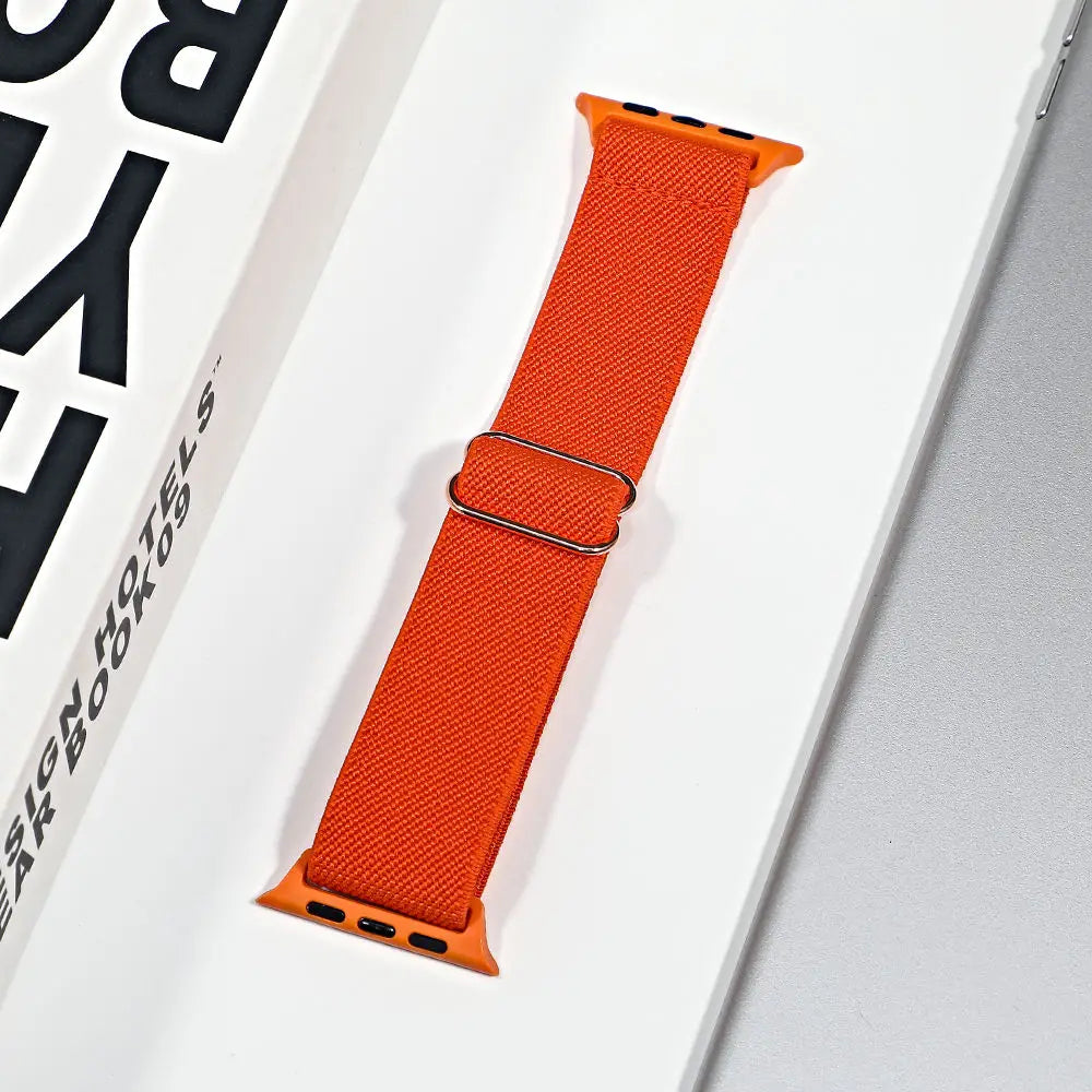 Apple Watch nylon sport loop strap in vibrant orange, designed for style and all-day comfort while being breathable.