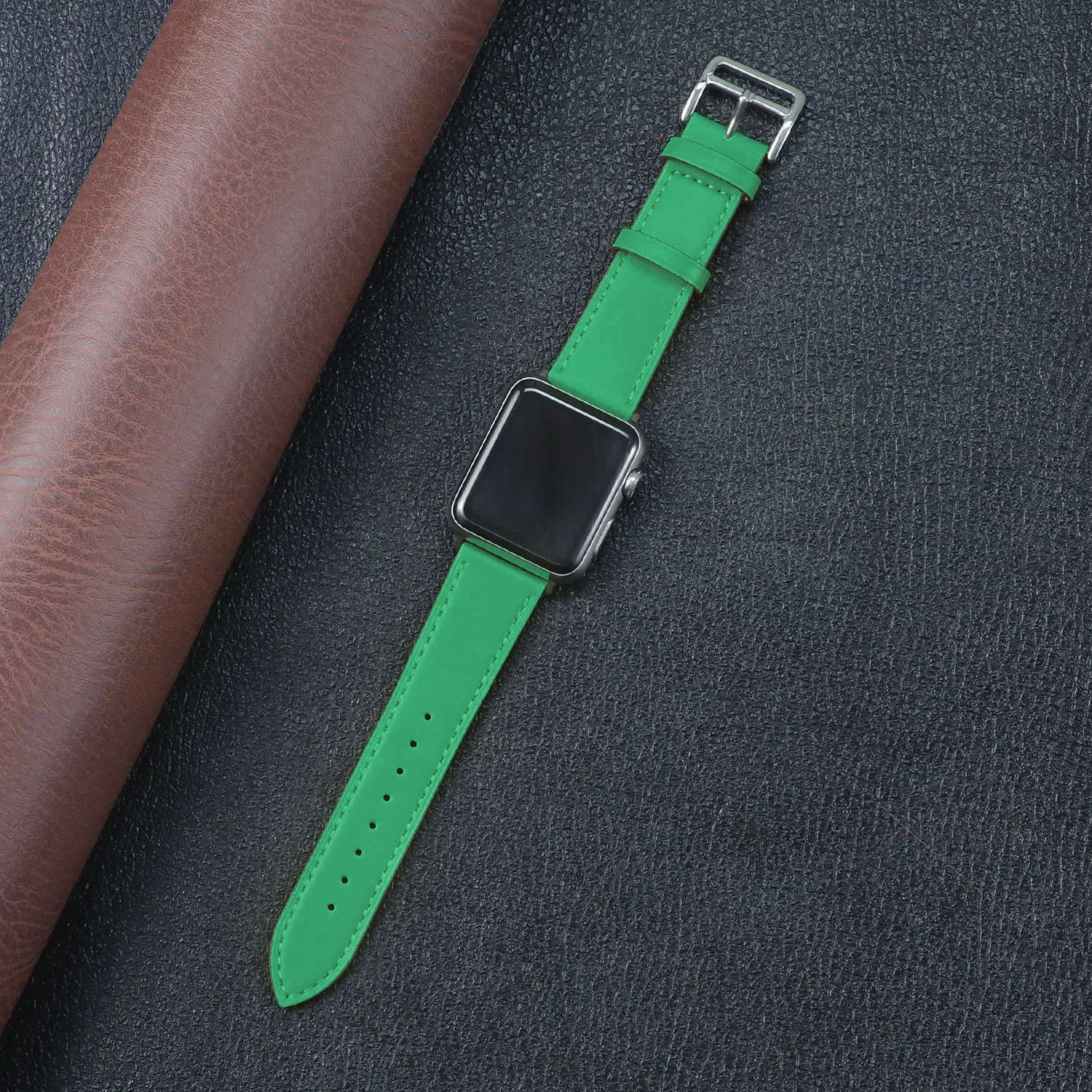 Green fabric strap for Apple Watch, featuring a metal buckle and a stylish design for comfort and durability.