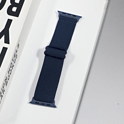 Navy nylon sport loop strap for Apple Watch, designed for comfort and breathability, displayed on a box.