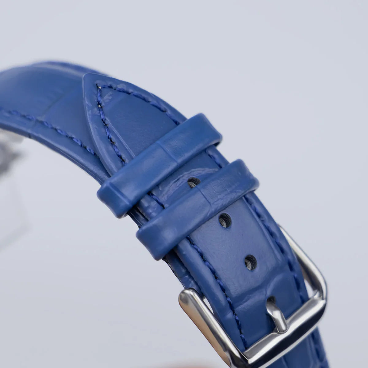 Close-up of a blue leather smartwatch strap with silver buckle, perfect for Garmin watch replacement.
