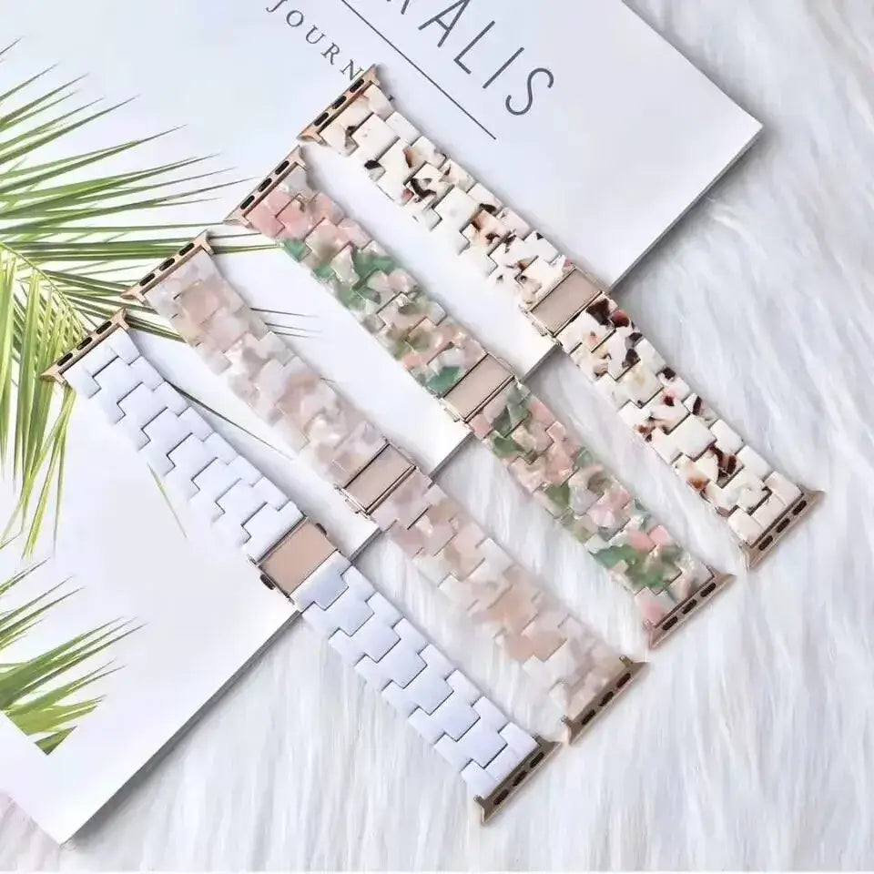 Assorted patterned resin Apple Watch straps laid flat