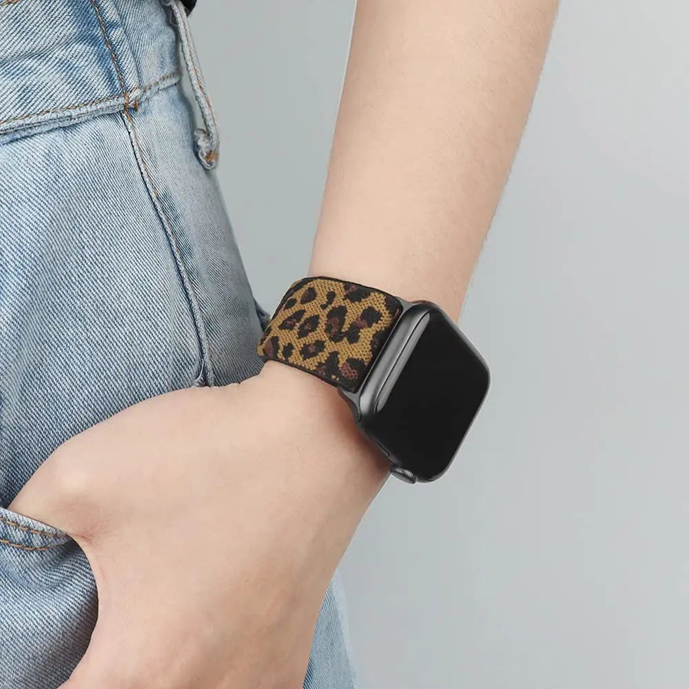 Apple Watch featuring leopard print nylon sport loop strap on a person's wrist, combining style and comfort.