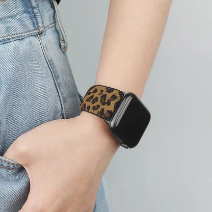 Apple Watch featuring leopard print nylon sport loop strap on a person's wrist, combining style and comfort.