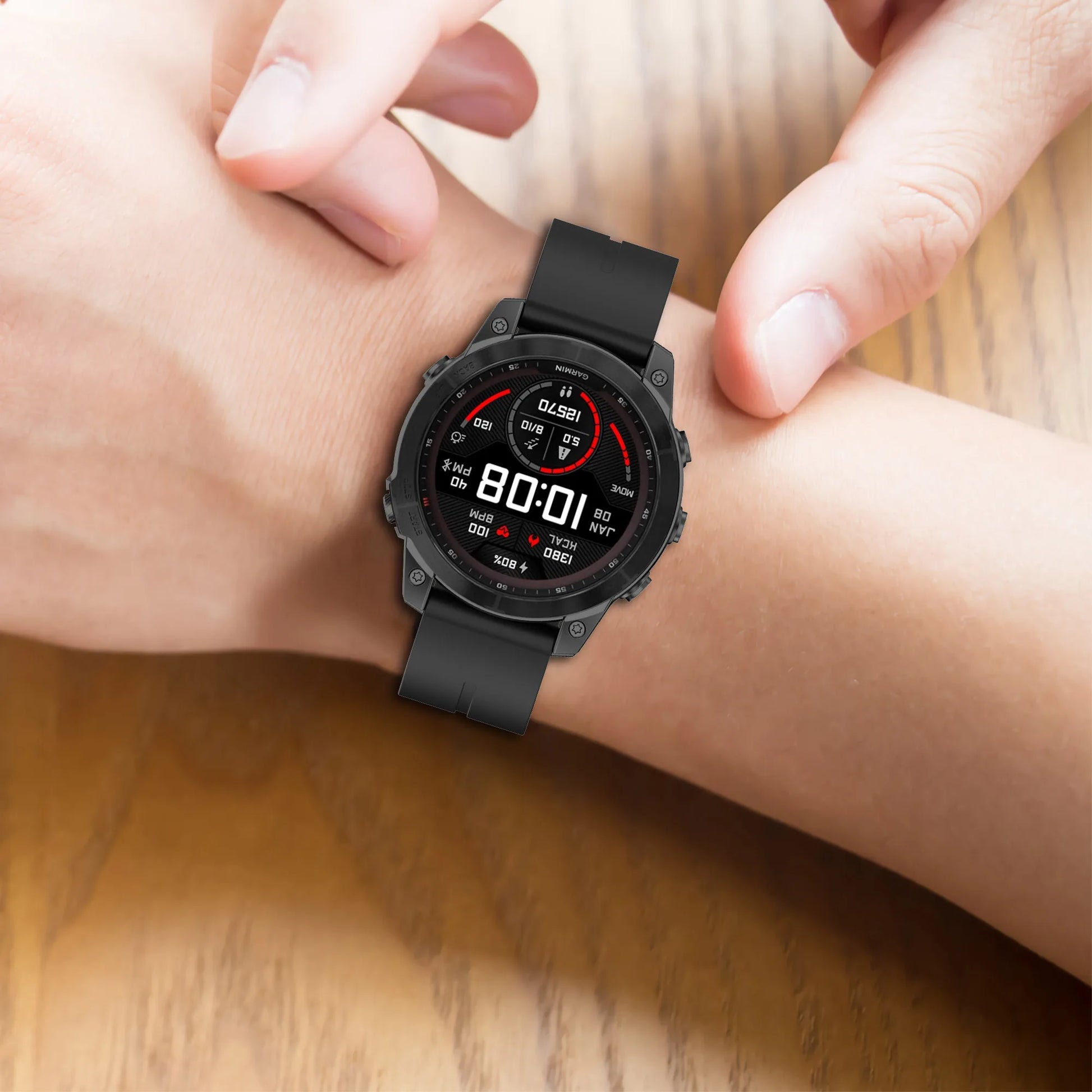 Garmin smartwatch with a black silicone strap on a person's wrist, displaying time and fitness stats for active lifestyle.