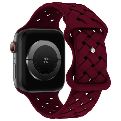 Apple Watch with burgundy silicone strap, sporty and breathable design for comfort and active lifestyles.