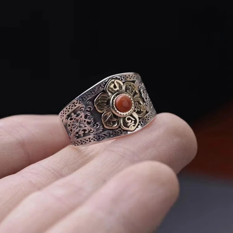 Carnelian flower ring held in hand, side view