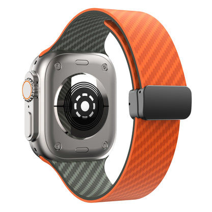 Apple Watch with orange silicone strap and magnetic buckle, featuring a durable design for comfort and security.