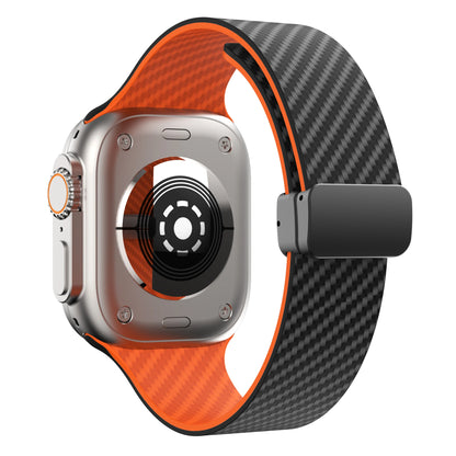 Apple Watch with black and orange silicone strap featuring magnetic buckle design for comfort and durability.