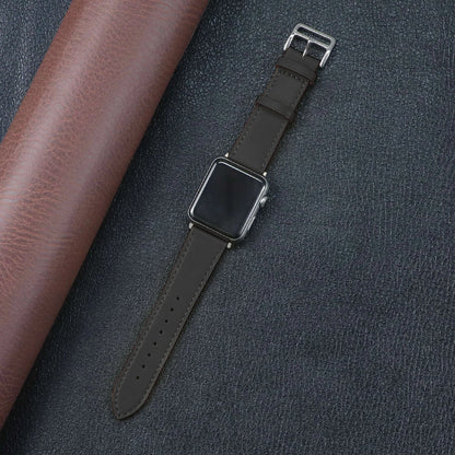 Apple Watch with a stylish brown fabric band, showcasing durability and comfort on a textured background.