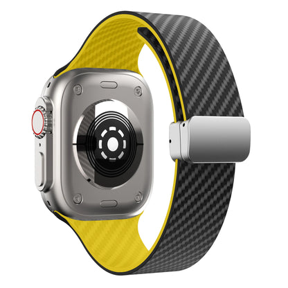 Apple Watch with carbon fiber and yellow silicone strap featuring a magnetic buckle for durability and comfort.