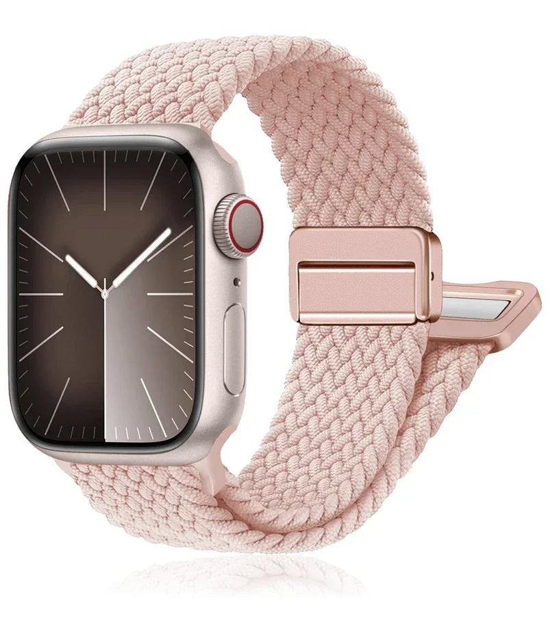 Apple Watch with braided nylon band in soft pink, featuring a stainless steel buckle for comfort and durability.