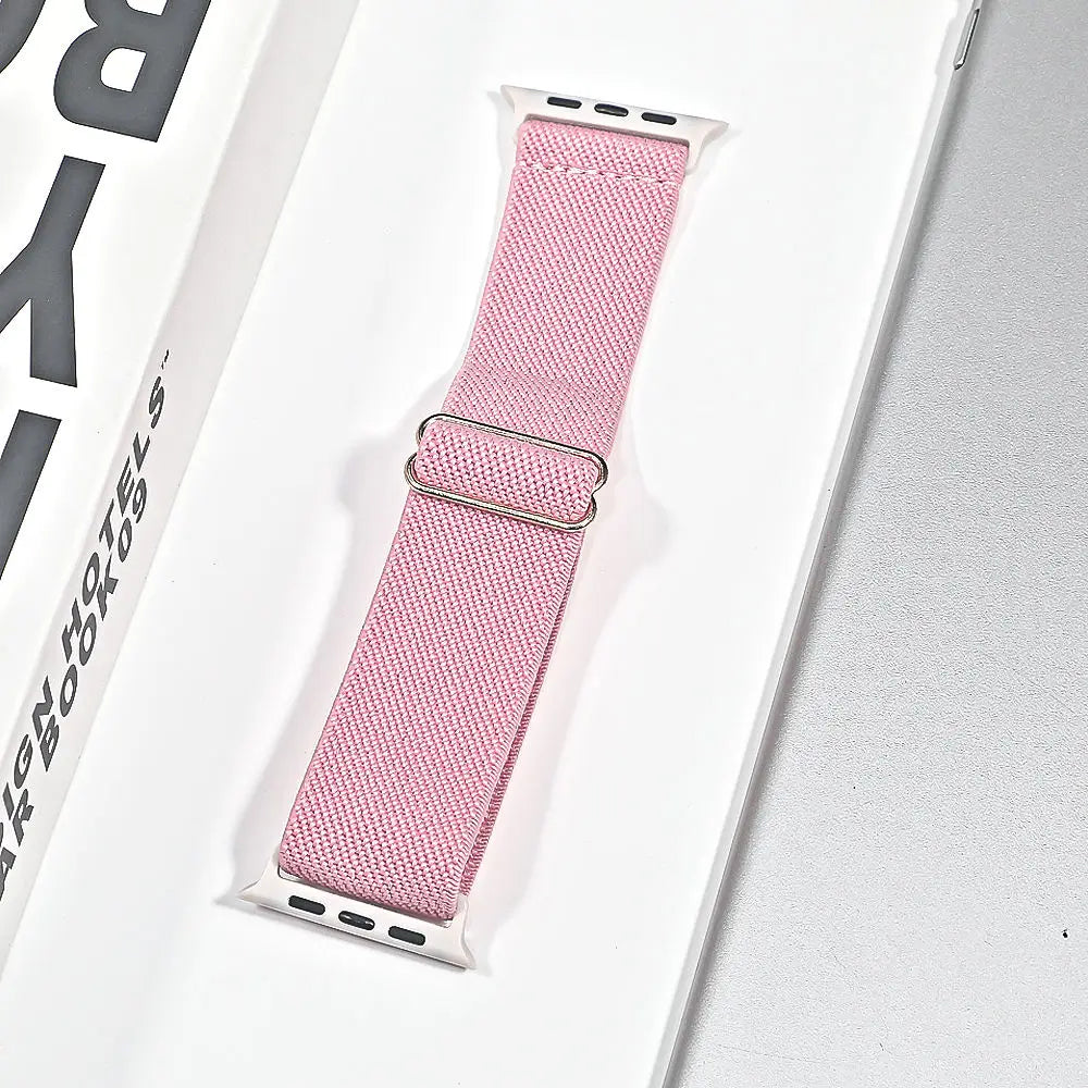 Apple Watch nylon sport loop strap in pink packaging, breathable and versatile for daily wear and workouts.