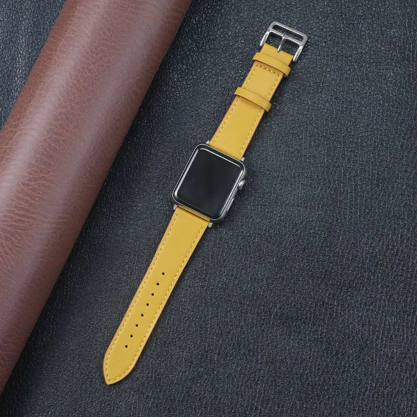 Apple Watch fabric band in vibrant yellow color, showcasing durability and style on a textured background.