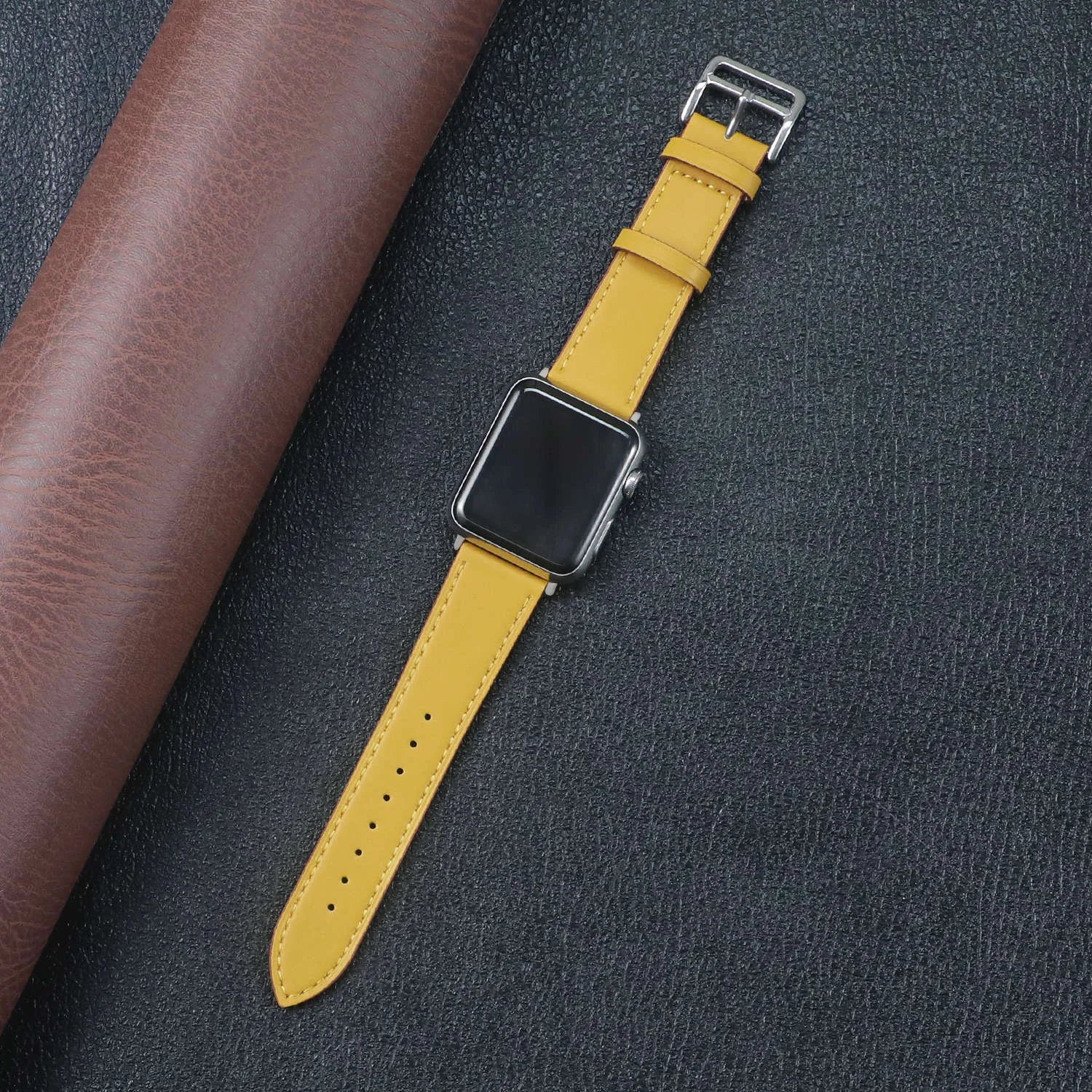 Apple Watch fabric band in vibrant yellow color, showcasing durability and style on a textured background.
