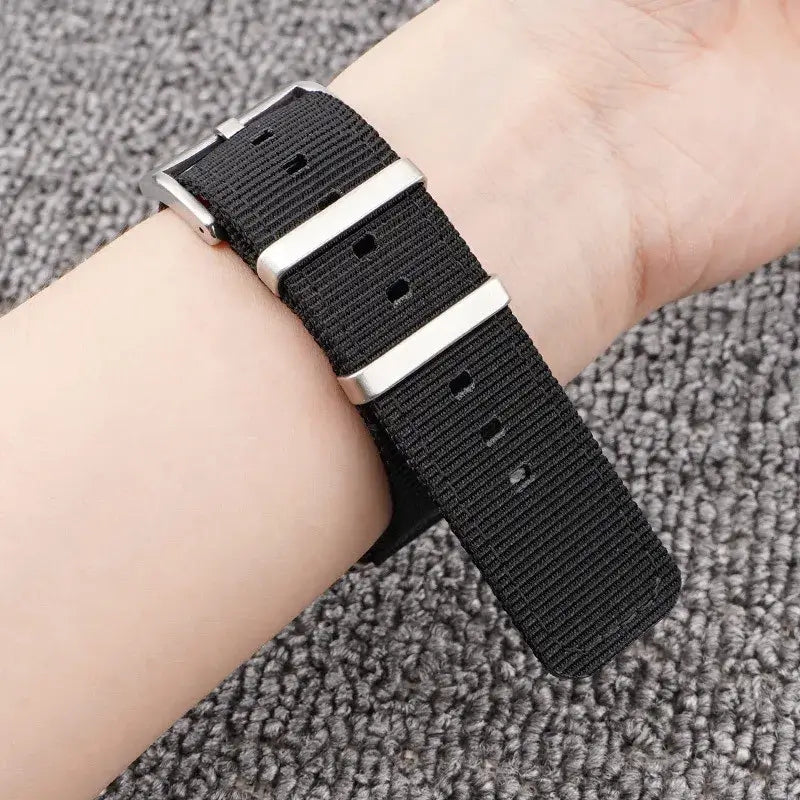 Black woven nylon band worn on a wrist