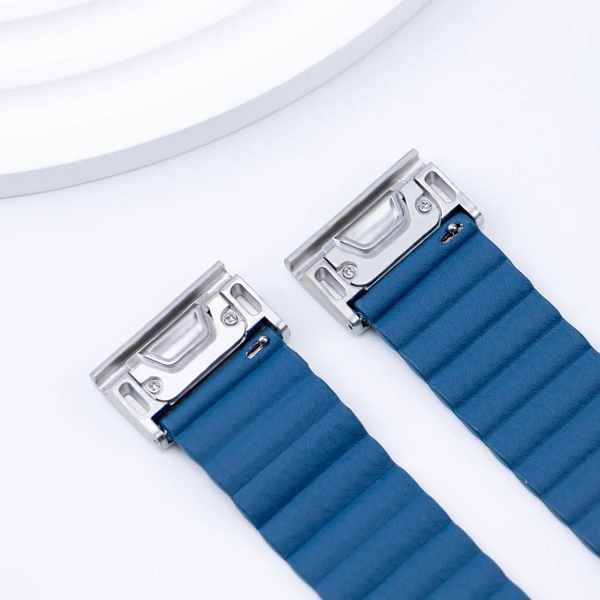 Close-up of a blue replacement Garmin smartwatch band with stainless steel buckle, showcasing its quickfit design.