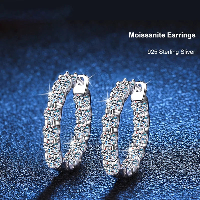 Round Moissanite Hoop Earrings in Plated Sterling Silver — Pair on blue surface