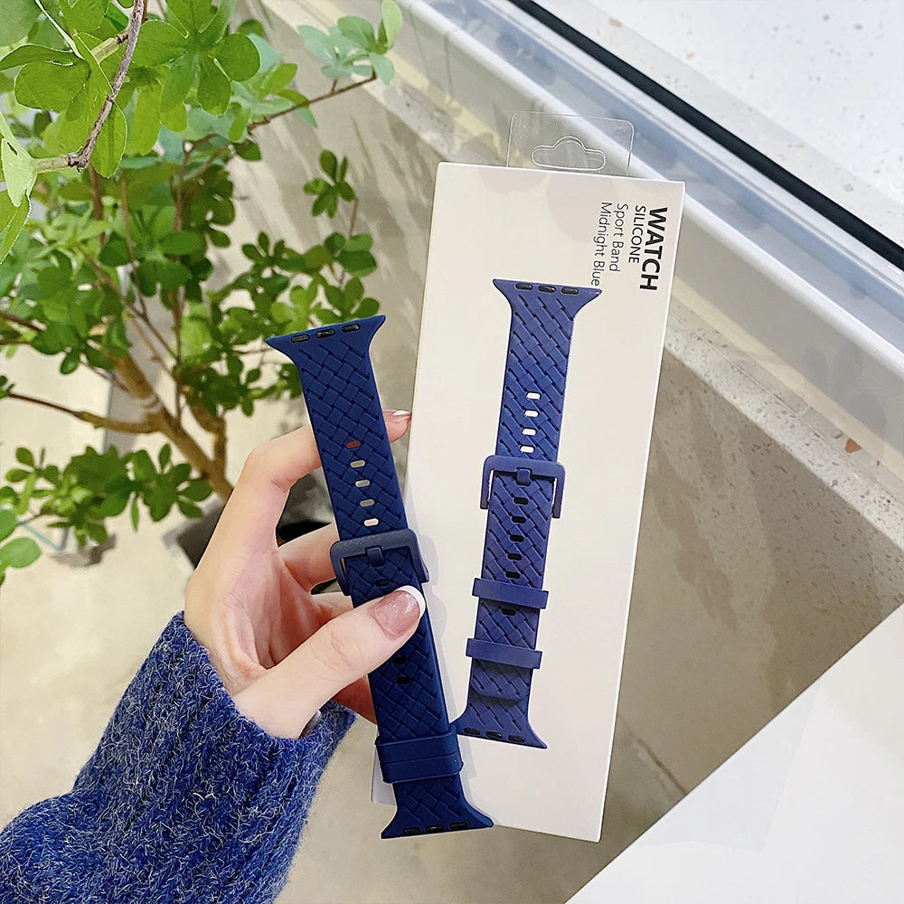 Apple Watch silicone strap in navy blue held by a person, showcasing comfort and style for smartwatches.