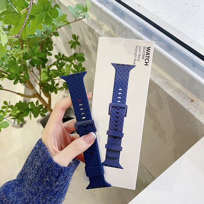 Apple Watch silicone strap in navy blue held by a person, showcasing comfort and style for smartwatches.