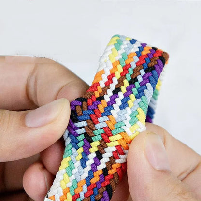 Colorful Garmin braided nylon strap being held, showcasing its lightweight and durable design for smartwatches.