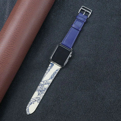 Apple Watch with a unique blue and white design fabric band, placed on a textured black surface.