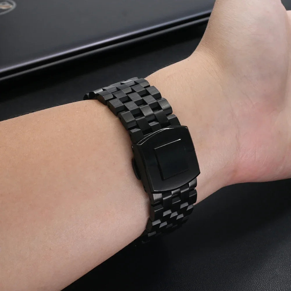 Garmin smartwatch band on wrist showcasing durable black stainless steel strap design.