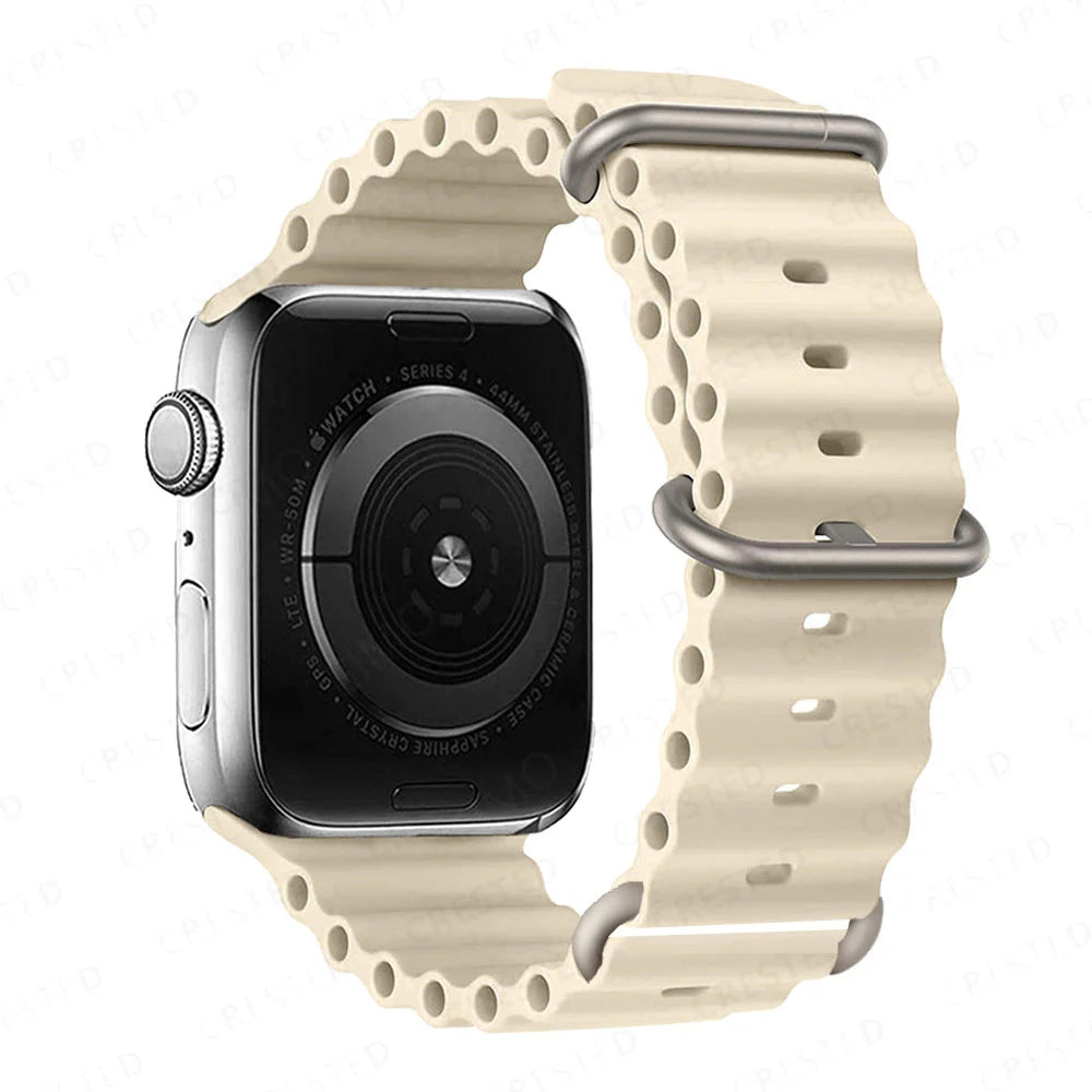 Apple Watch with a cream silicone strap, waterproof and breathable for comfort during workouts and water activities.