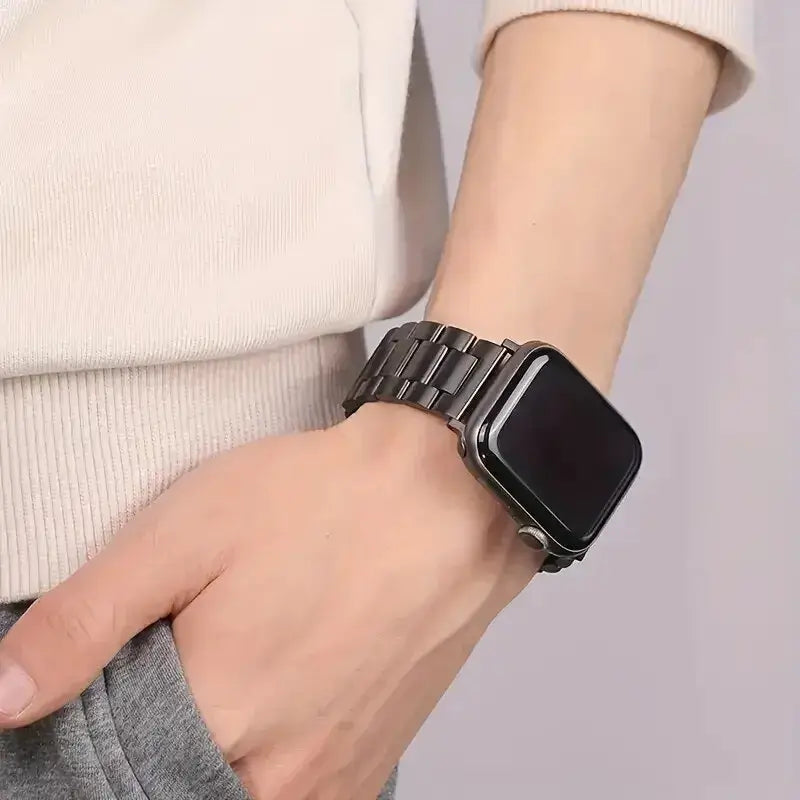 Black wide-link Apple Watch bracelet worn on wrist