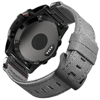 Garmin smartwatch with rugged nylon sport band, showcasing durable woven strap and secure G-hook closure.