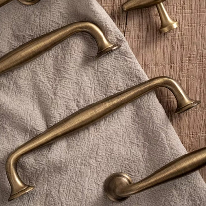 Arched solid brass cabinet pull in antique brass