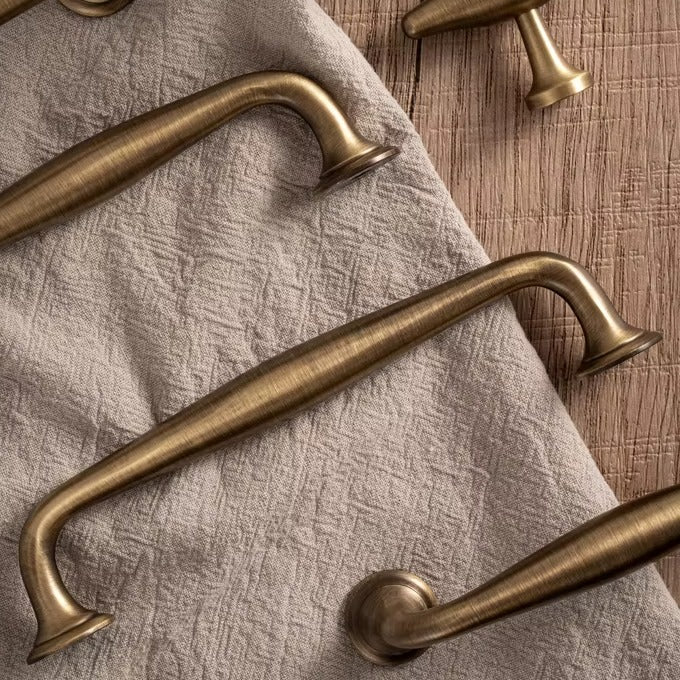 Arched solid brass cabinet pull in antique brass