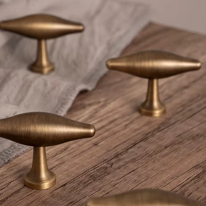 Arched olive-shaped solid brass T-bar cabinet knob in antique brass