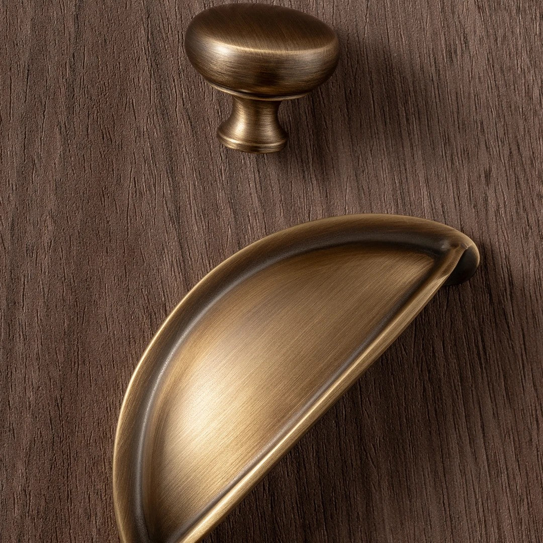 Bow solid brass mushroom knob and half-moon cup pull in antique brass