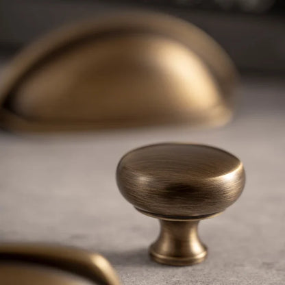 Bow solid brass mushroom cabinet knob in antique brass